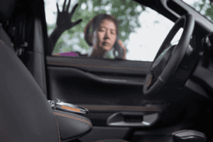 A locksmith unlocking a car door with a coat hanger